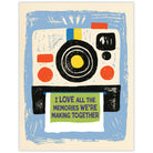 Retro camera printing a photo with a love message